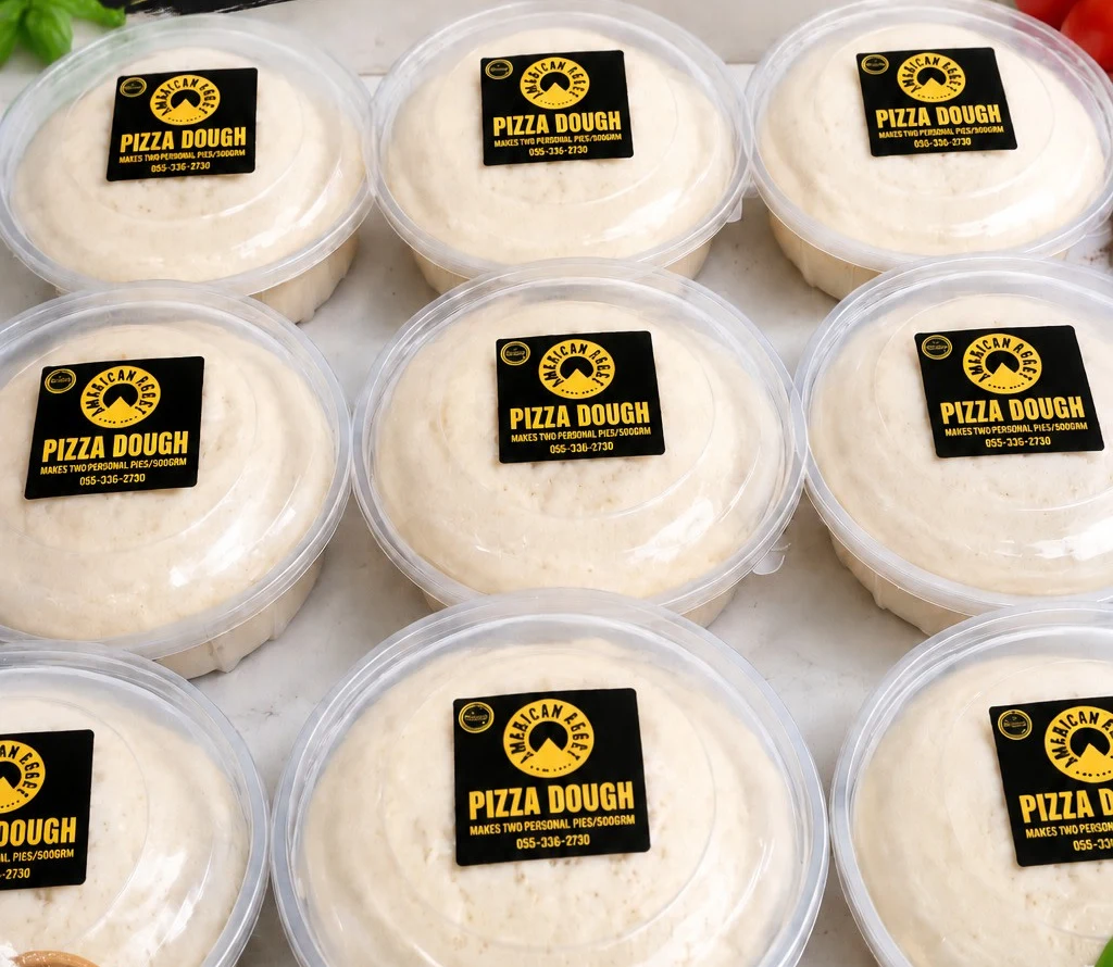 Tubs of American Crust pizza dough in rows