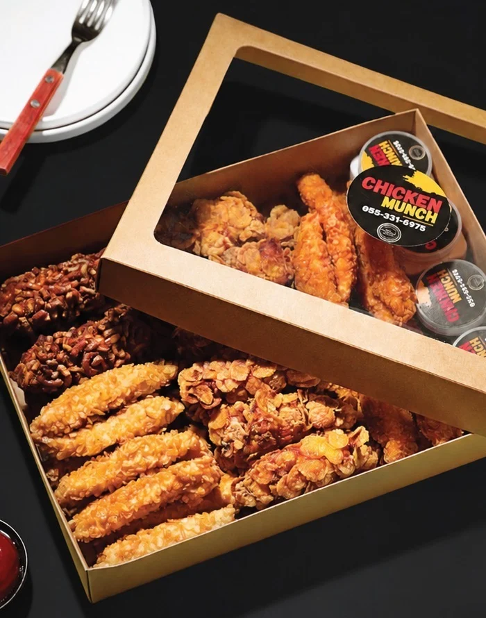 A Chicken Munch box: pretzel, rice krispie and cornflake chicken with sauce pots in the lid