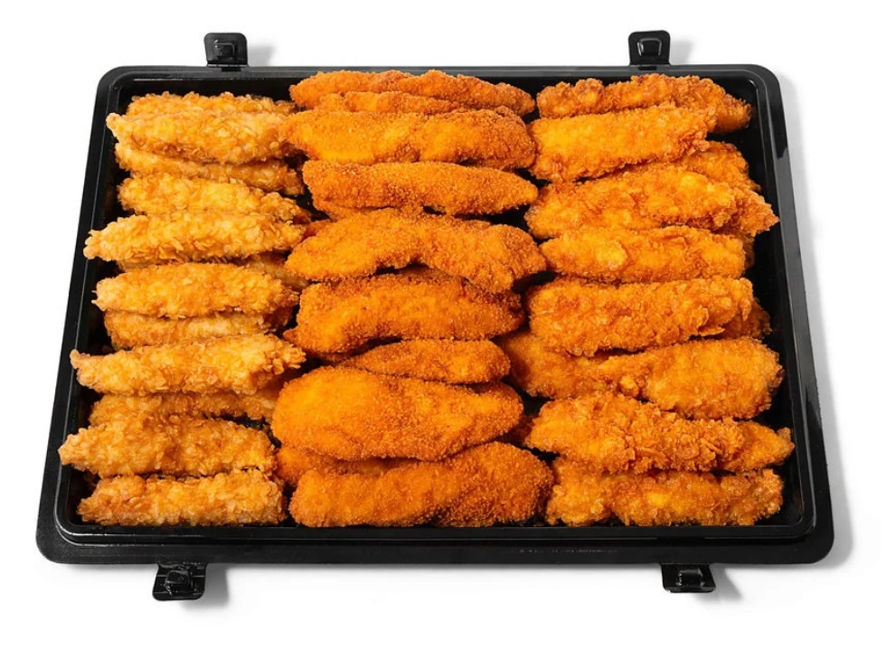 A large black pan packed with golden fried chicken tenders