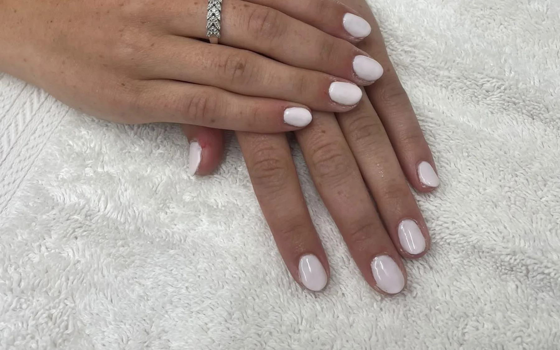 Milky white gel nails on a client