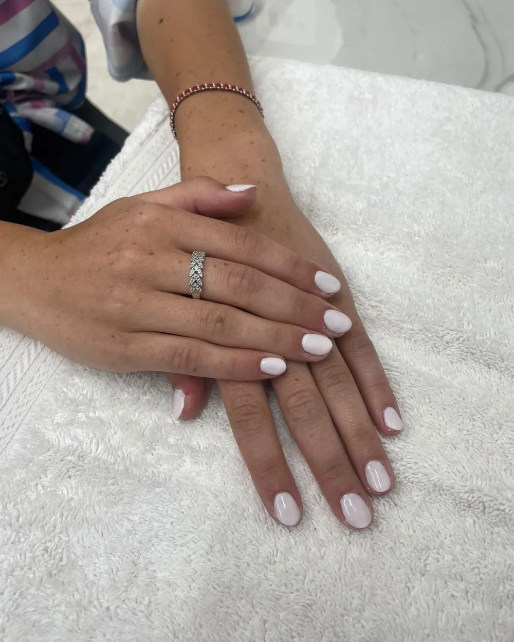 Milky white gel nails on a client