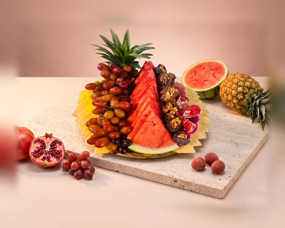 The Small platter: a round board with watermelon, red grapes, dates and pineapple