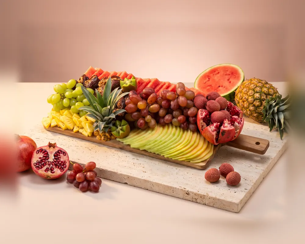 The Large platter: a long wooden board of watermelon, grapes, lychees, pomegranate and melon