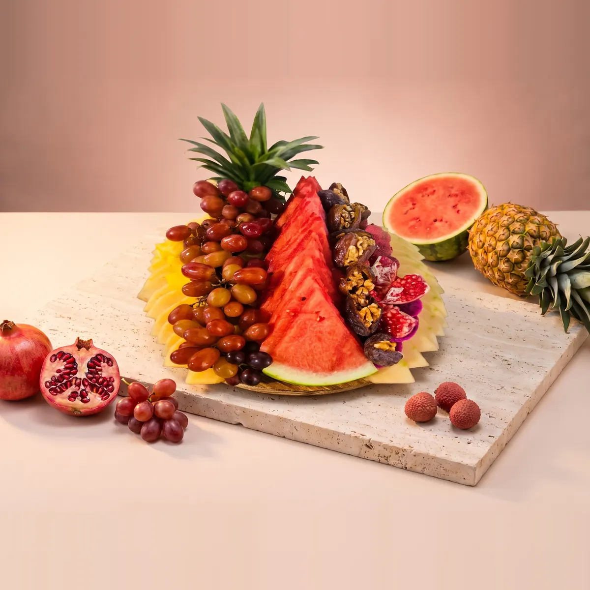 The Small platter: a round board with watermelon, red grapes, dates and pineapple