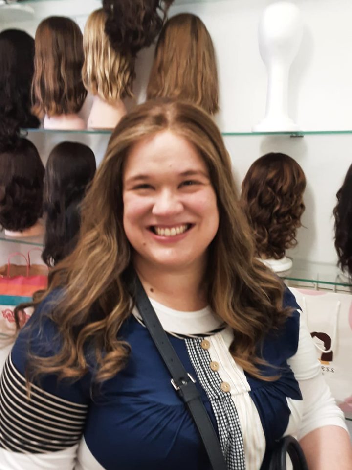 A client in a long wavy honey-brown wig