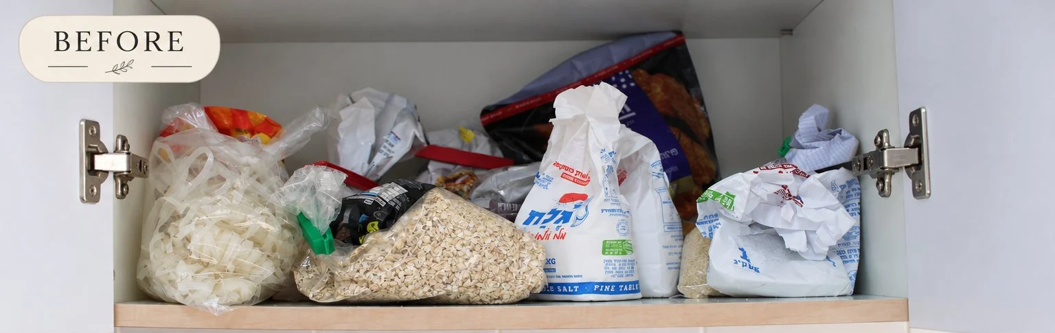 A kitchen cupboard shelf with loose bags of food