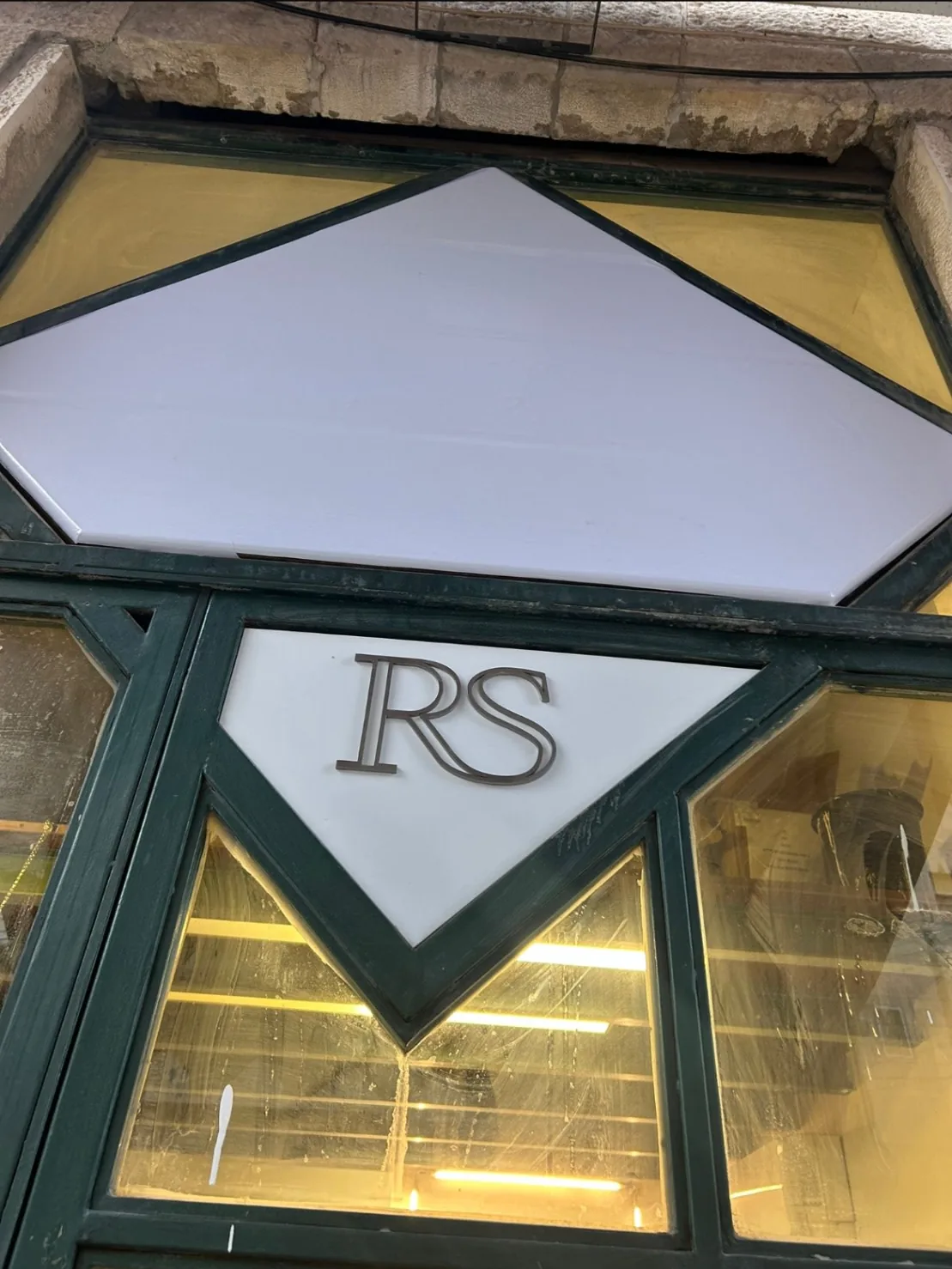The RS sign in a green window frame