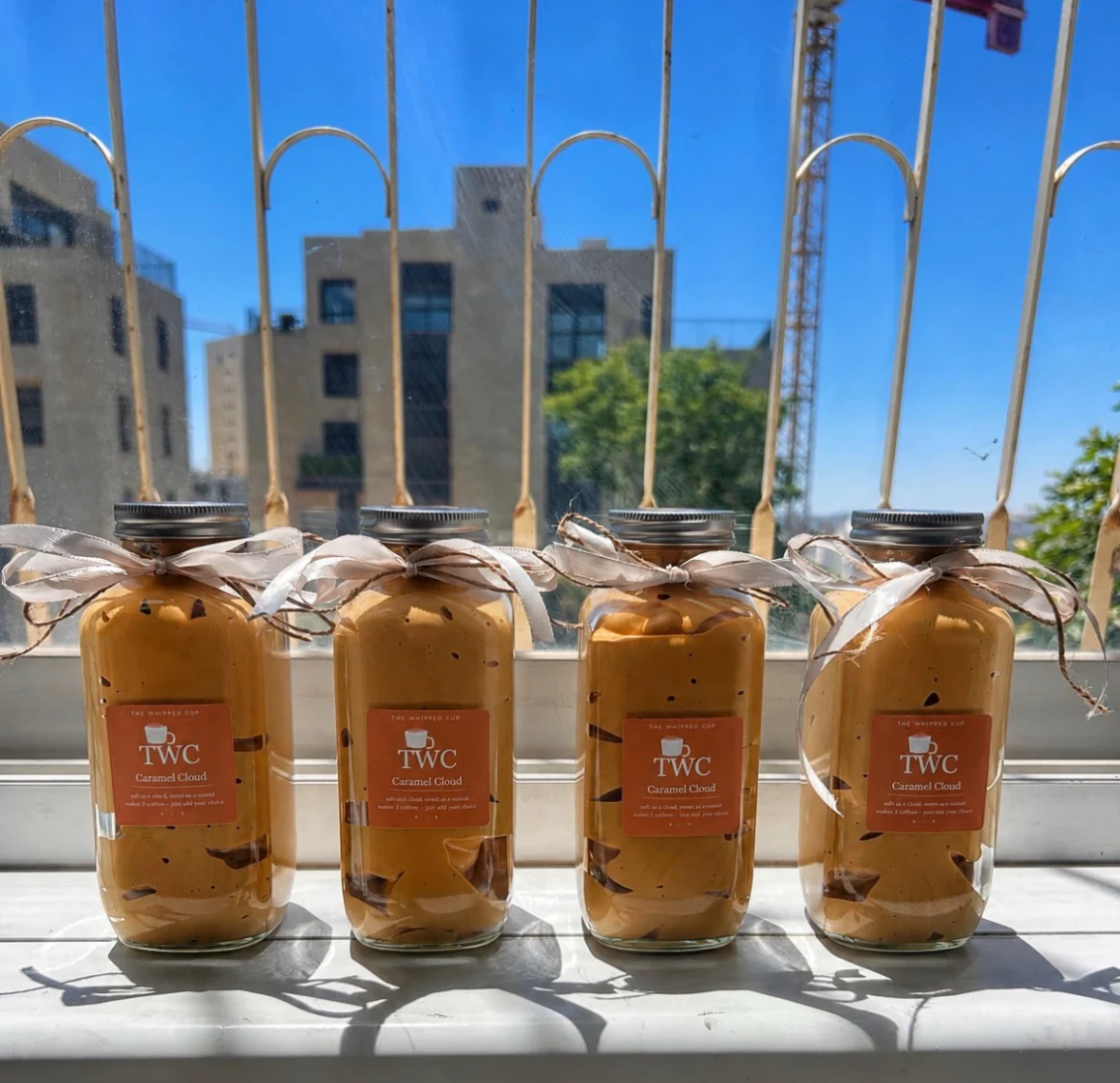 Four jars of Caramel Cloud on a sunny window sill in Jerusalem