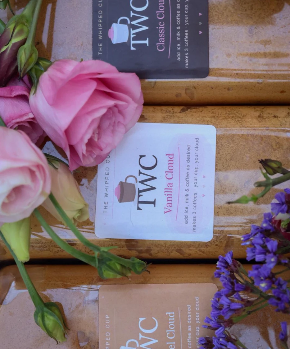 Jars of Vanilla Cloud and Classic Cloud among roses