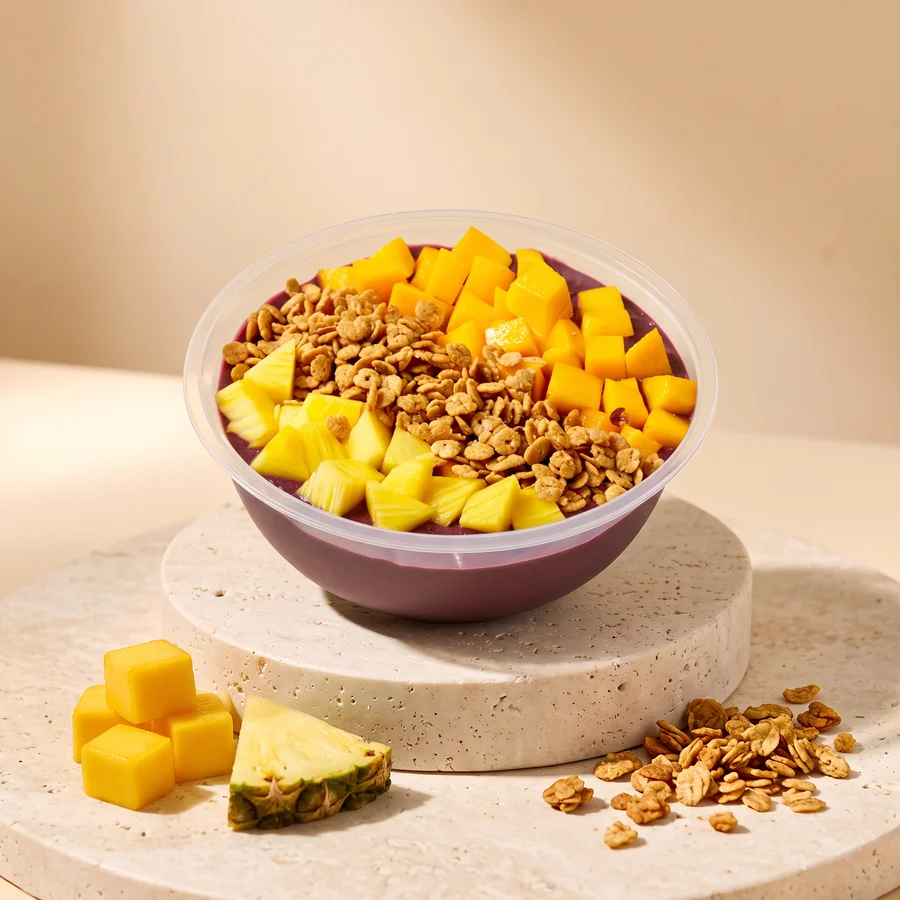 A Tropical bowl: frozen mango, frozen pineapple and super granola on our acai base