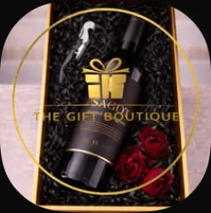 A bottle opener with a bottle and red roses in a black box with our gold logo